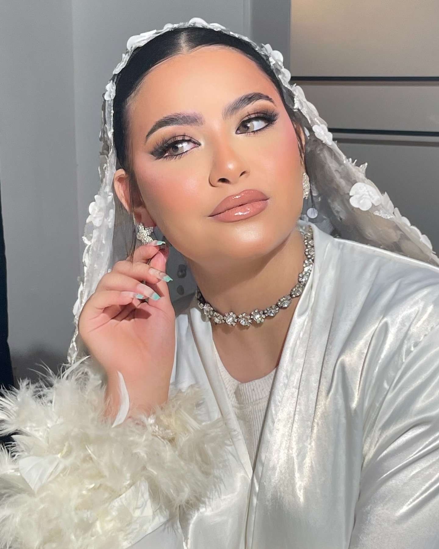 Bride in a floral lace veil with glowing soft glam makeup